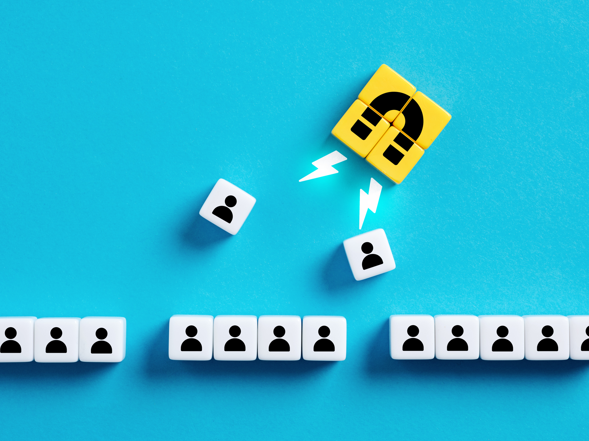 Choosing the best candidate for hiring. Recruitment, staffing and human resources management. Employee selection. Attracting new customers or followers. Magnet pulls employees out of row of cubes.