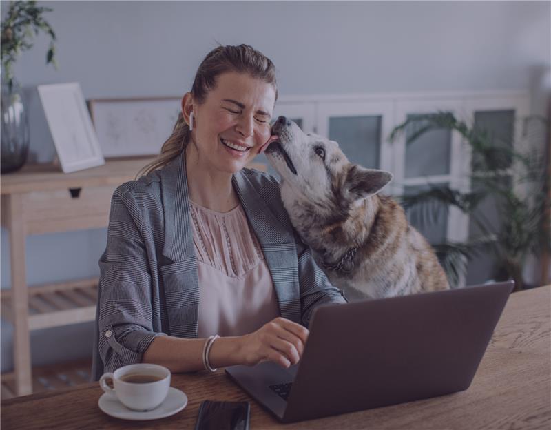 Professional woman working at home with her dog